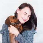 Women holding her new dachsund.
